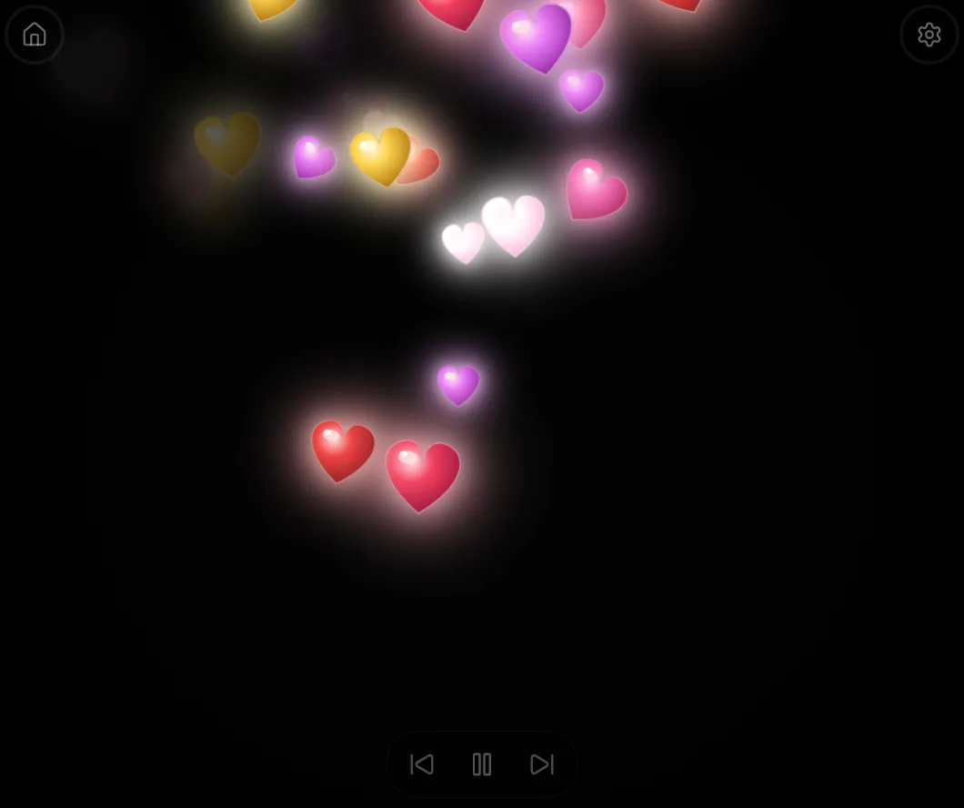 Pink, red, yellow and purple hearts drifting on a black Spark Worlds screen.